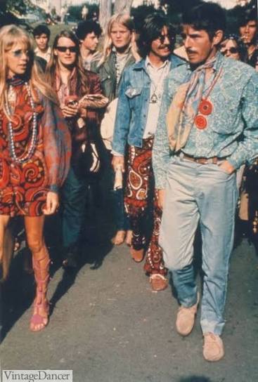 People in vibrant 1960s attire with patterns and accessories walking outdoors.